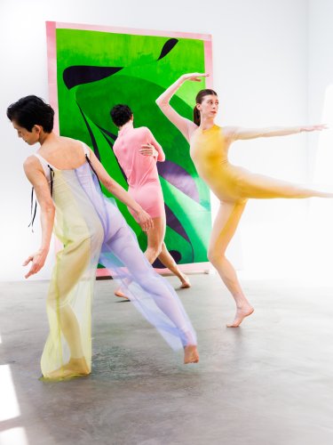 Dancers performing in front of an exhibition.