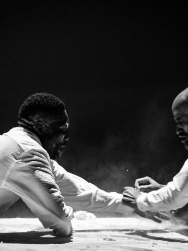 Two men in whit shirts at a table, black and white photo.