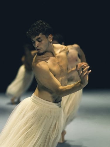 Dancers in long white tutus