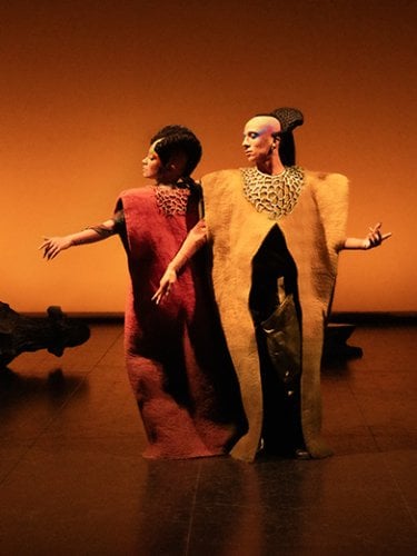two dancers on an orange background