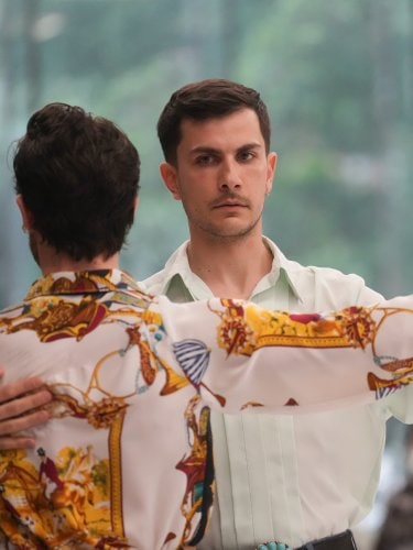 Two dancers, one with their back to the viewer, the other facing forward.