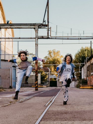 choreographers running and shouting in a street 