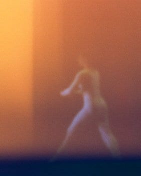 Dancer on stage, blurred by the lights.