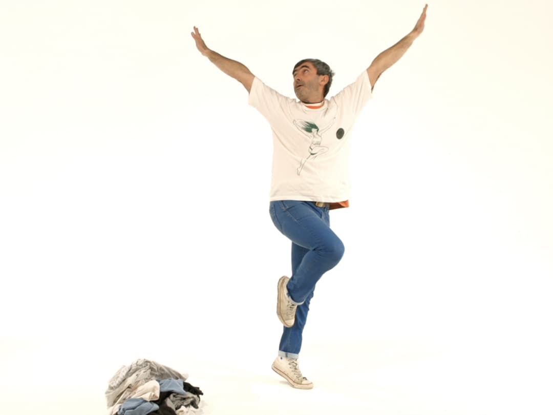 Man standing on one foot with arms raised