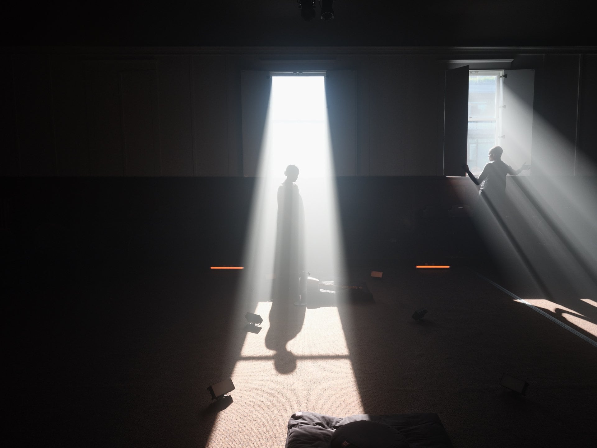A silhouette in a beam of light.