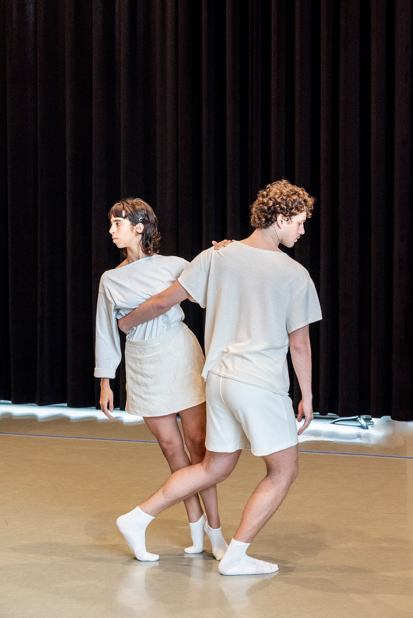 Two dancers from the CNSMDP holding each other in balance