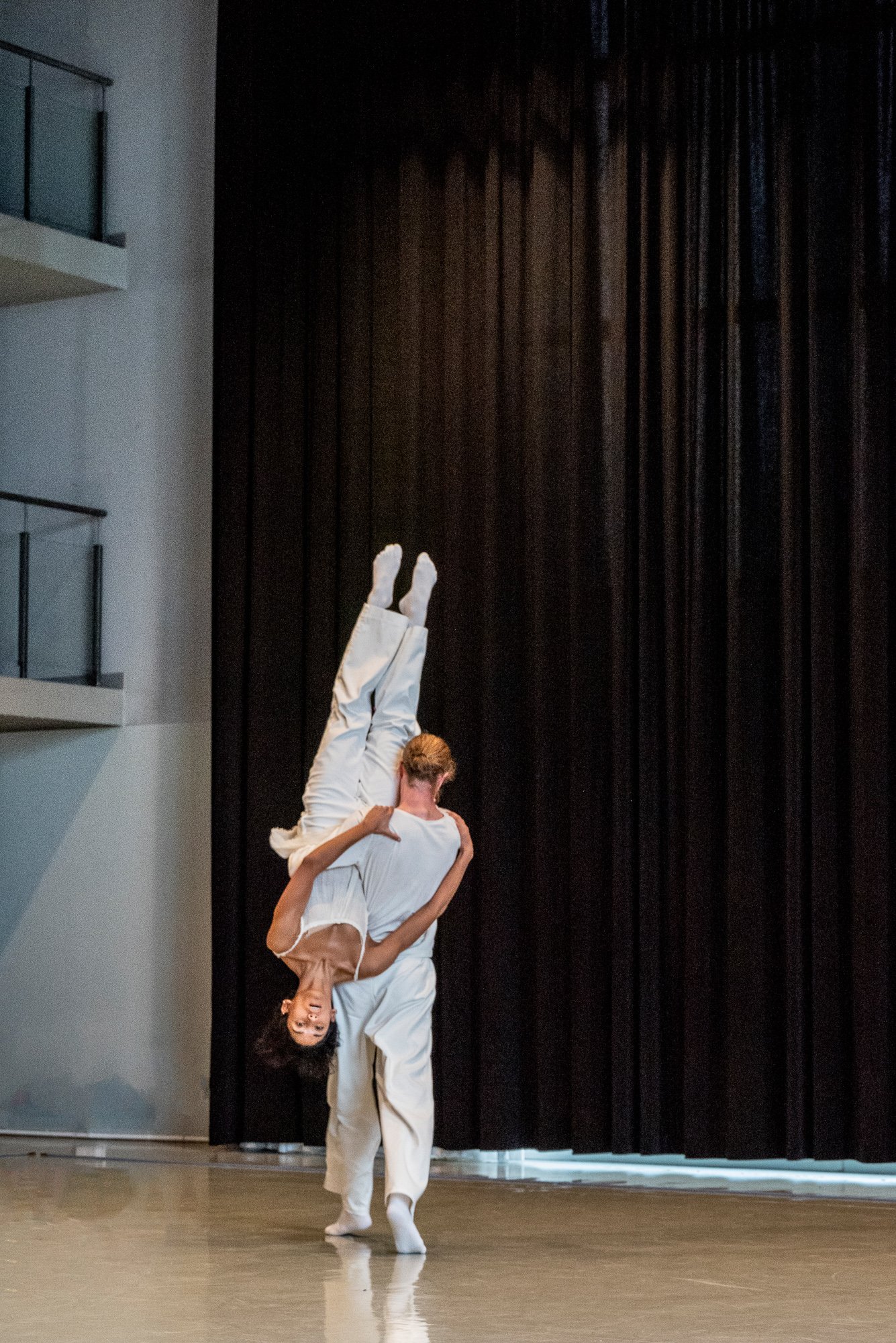 A dancer carrying another dancer