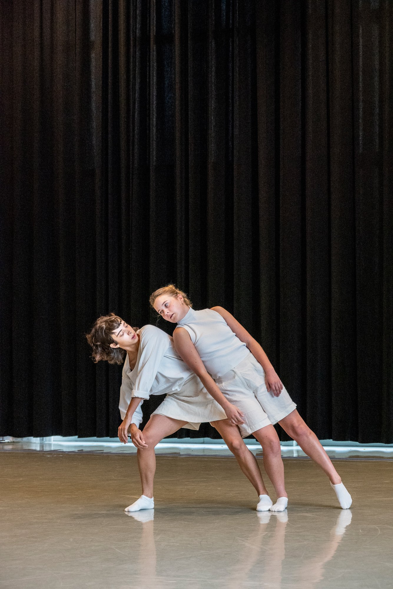 A dancer leaning on another dancer