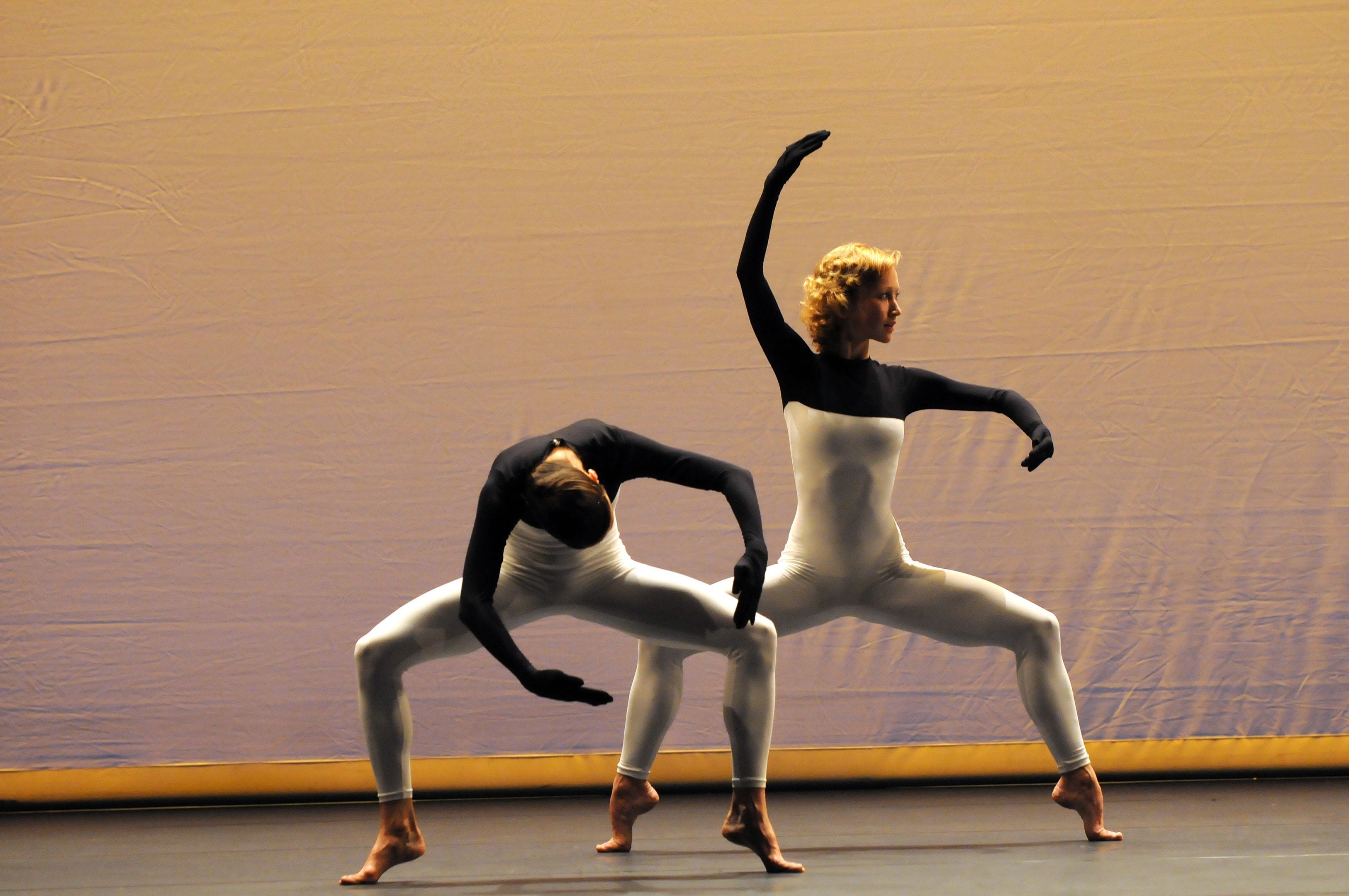 two dancers on a yellow-orange background