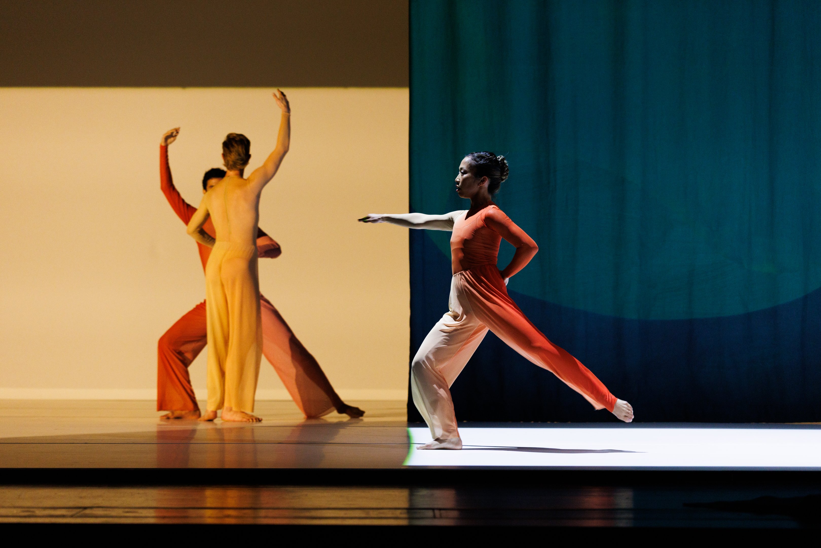Three dancers, two of whom are in a yellow square, and one dancer in a green square