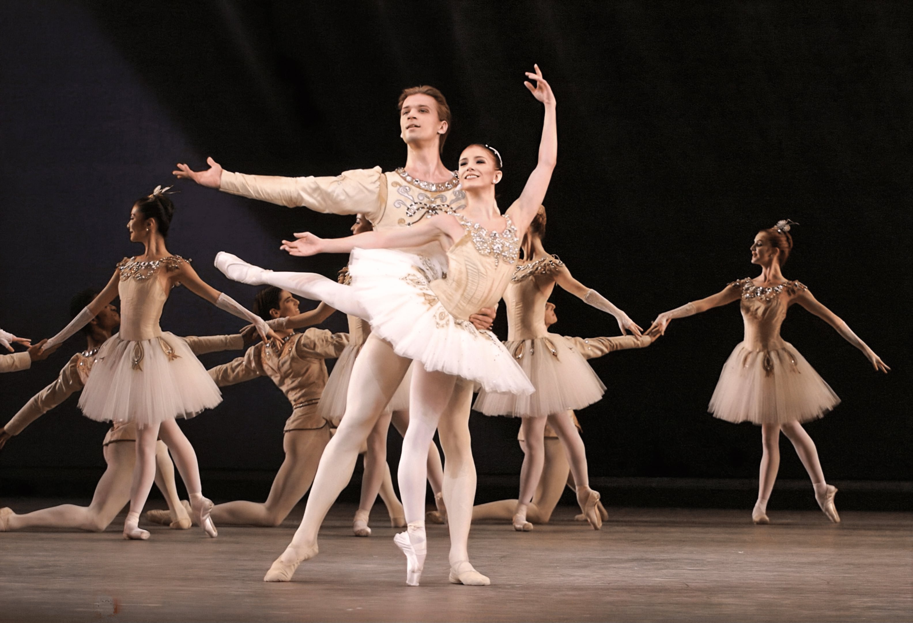 Photo d'une représentation du ballet Joyaux montrant deux danseurs face au public avec d'autres danseuses en arrière-plan