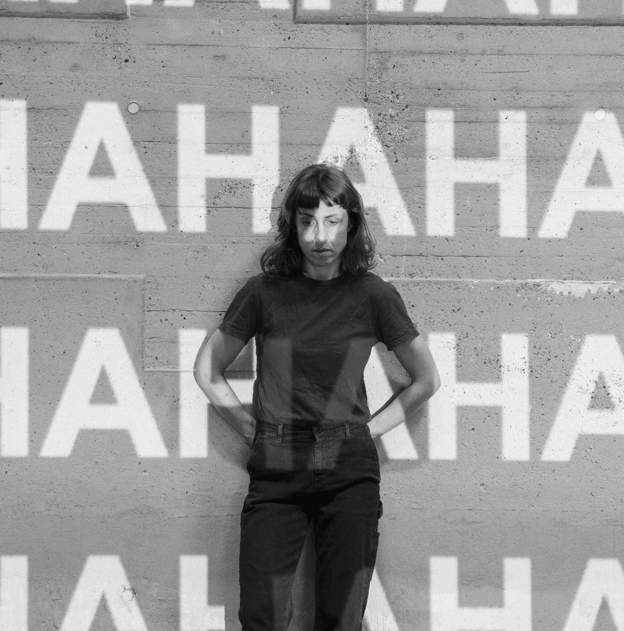 Full-length portrait of the artist, with superimposed writing projection