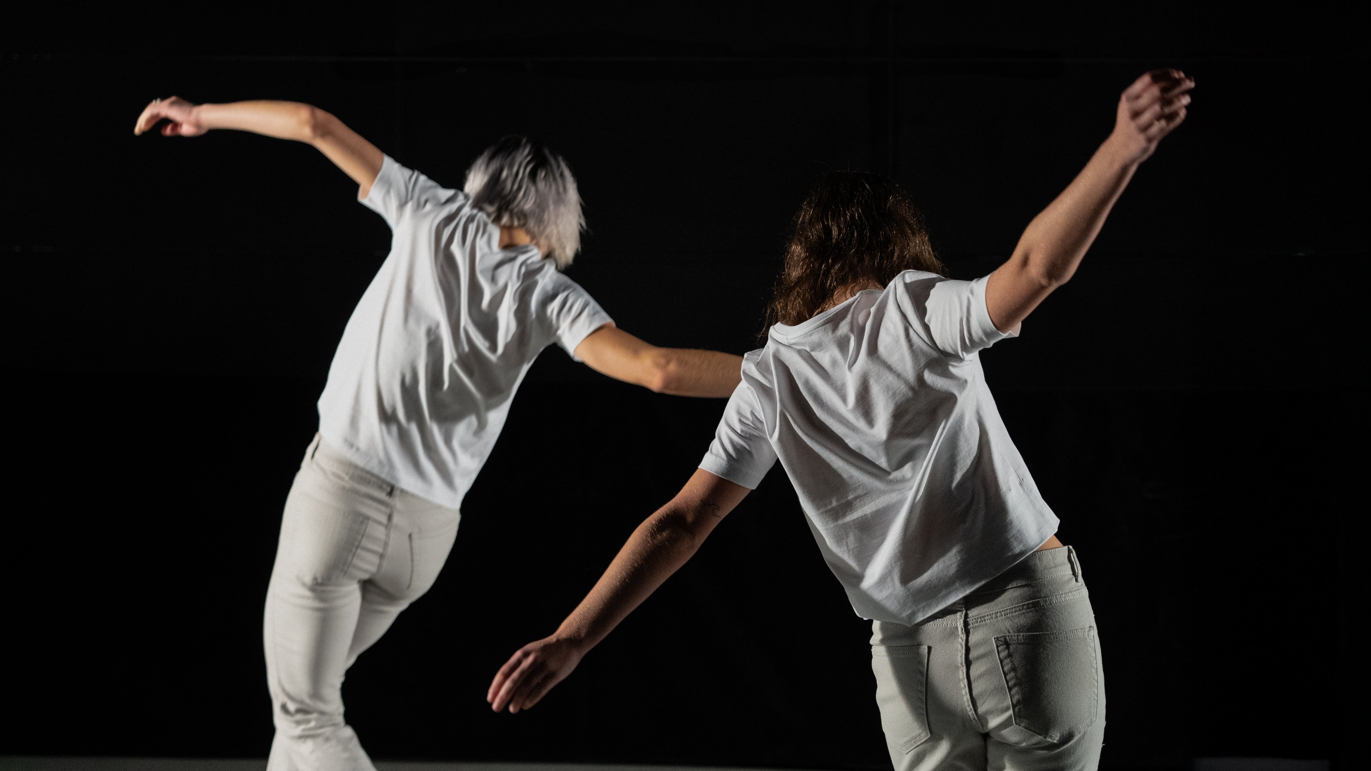 Two dancers dressed in white.