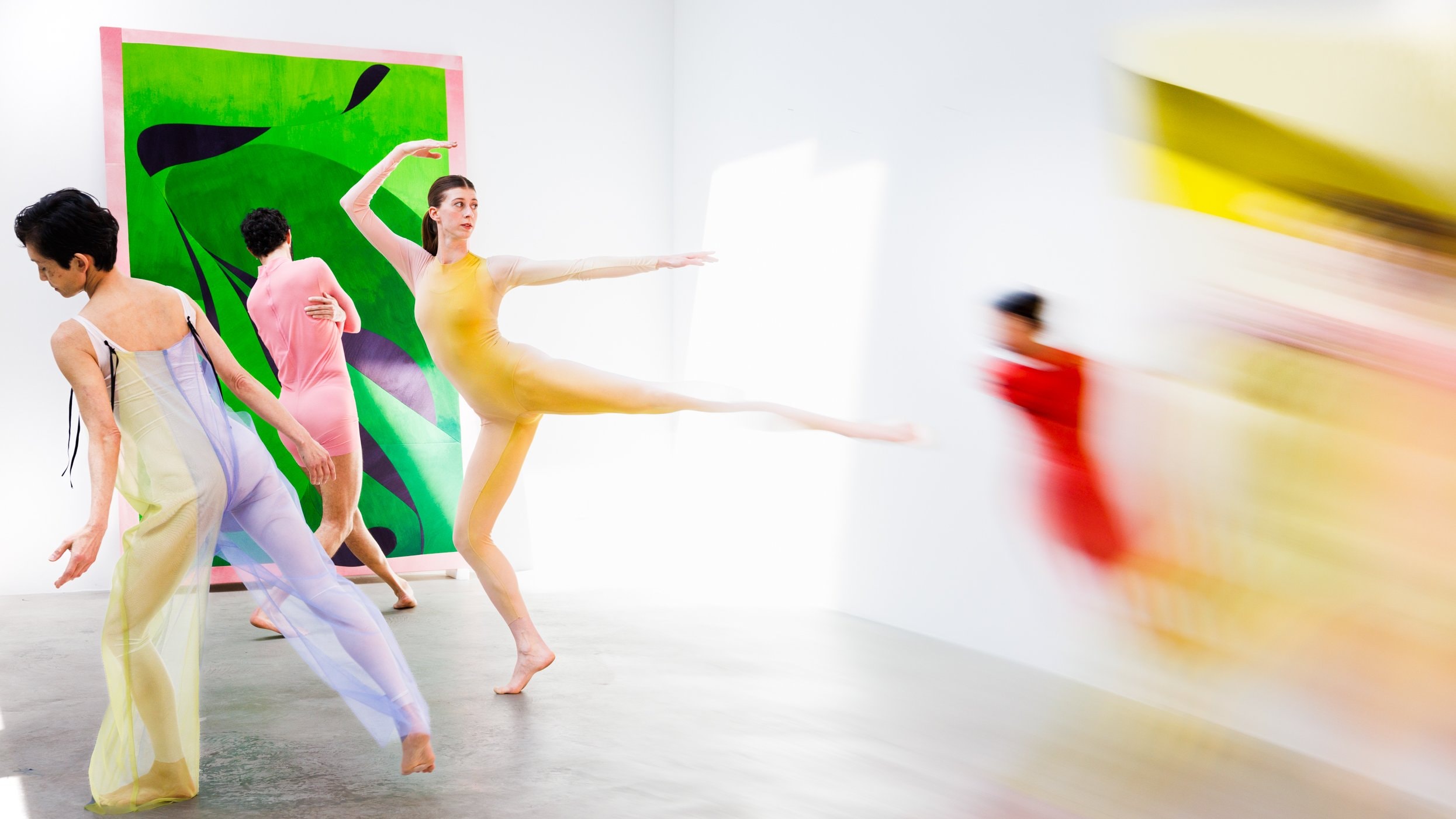 Dancers performing in front of an exhibition.