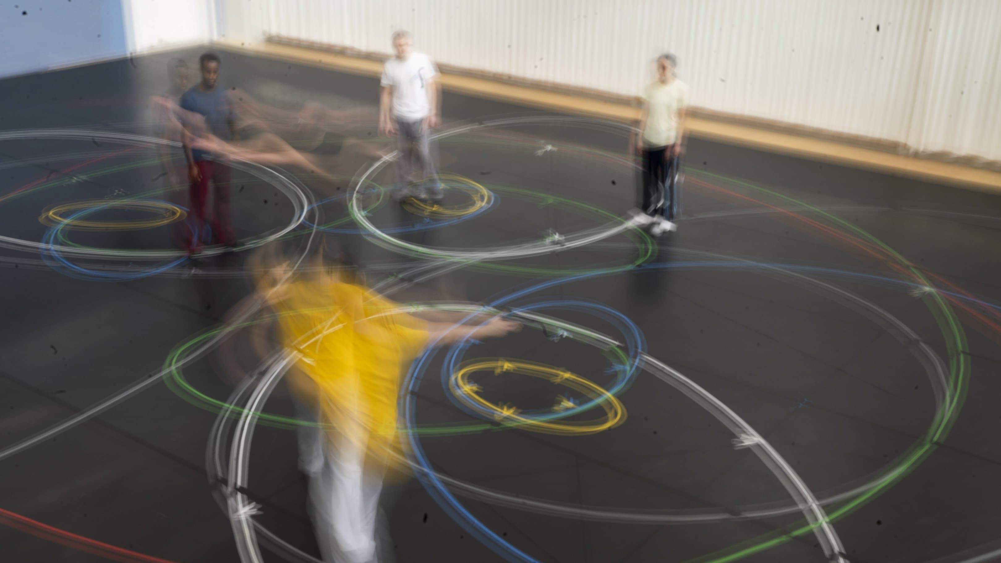 People moving, creating colorful light trails