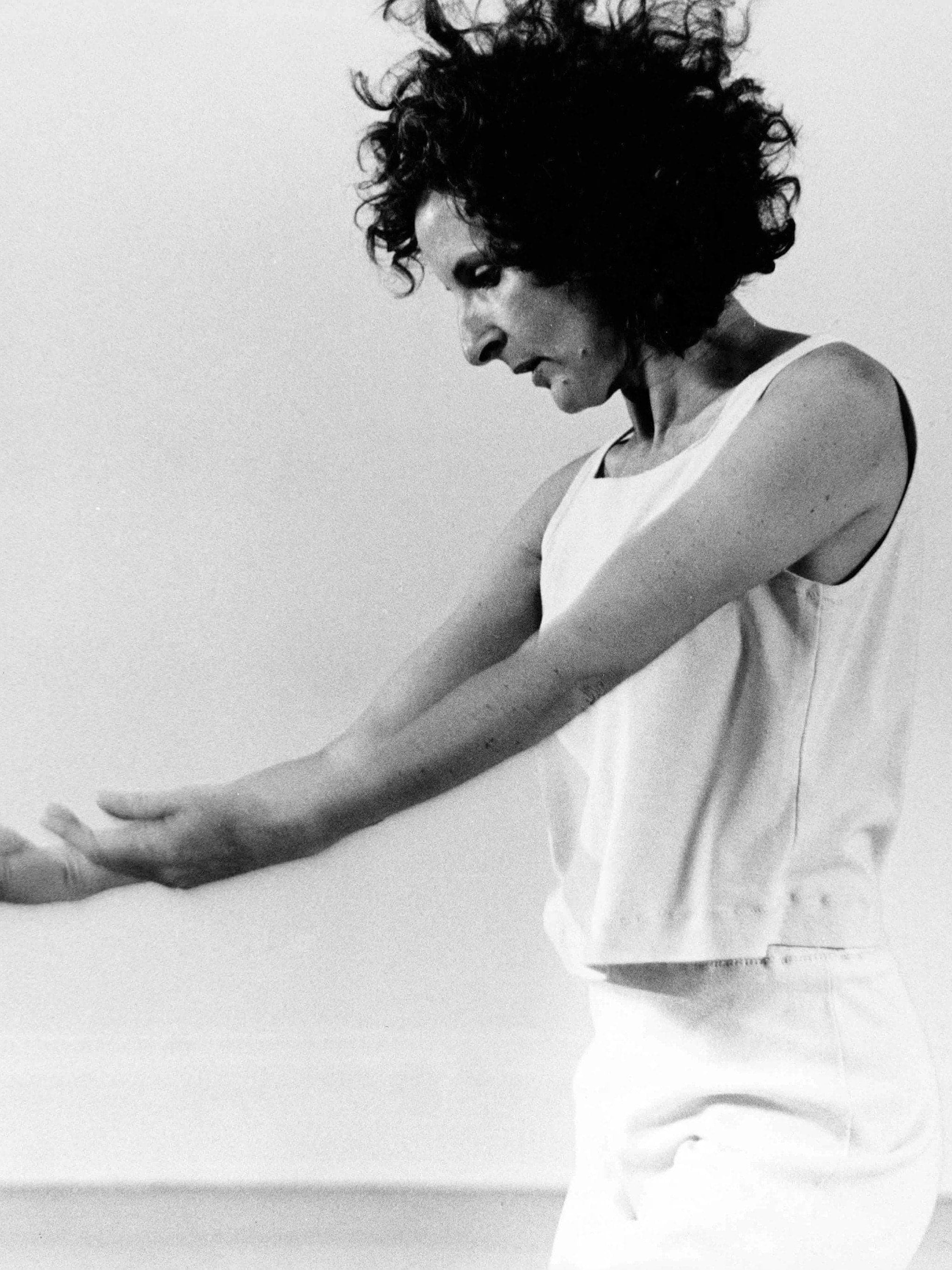 Black and white portrait of Trisha Brown dancing