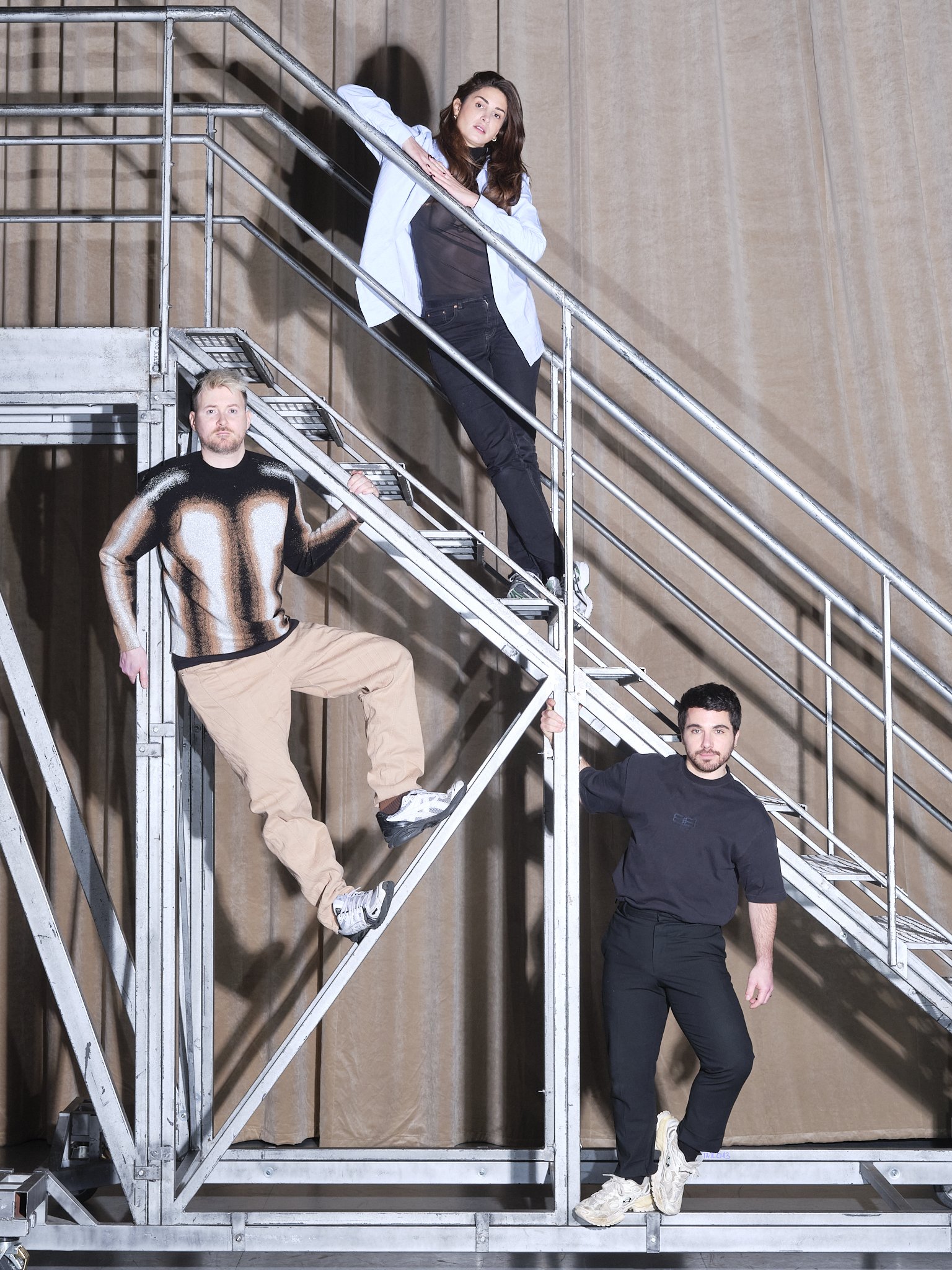 Portrait (LA) HORDE two men and a woman on a metal staircase"